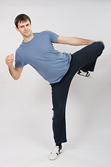 Image showing Young man flexing muscles of the legs