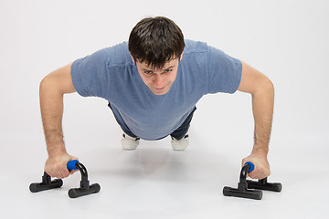 Image showing Tired athlete is pushed on supports