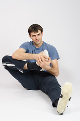 Image showing Athlete flexing the foot of right leg