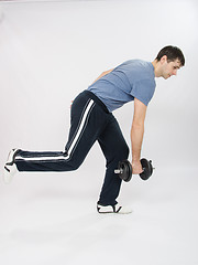 Image showing athlete performs a slope with dumbbells standing on one leg