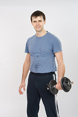 Image showing Portrait of an athlete with dumbbells in the hands