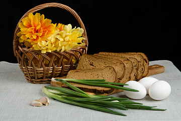 Image showing Still life with rye bread, green onions and eggs