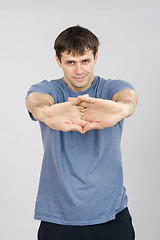 Image showing Athlete pulls the arm muscles