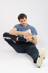 Image showing The athlete performs a workout right foot