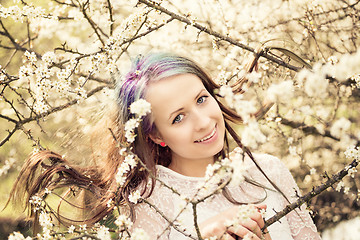 Image showing Portrait of cheerful fashionable woman in spring blooming tree