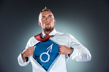 Image showing businessman acting like a super hero and tearing his shirt off