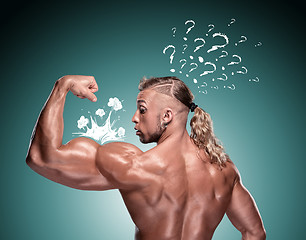 Image showing Attractive male body builder on blue background