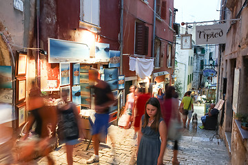Image showing People walking next to displayed souvenirs in Rovinj