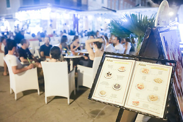 Image showing Tourist menu displayed in front of restaurant on promenade