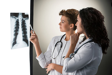 Image showing Two attractive young doctors looking at x-ray results