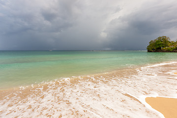 Image showing Beach on tropical island. Clear blue water, sand, clouds. 