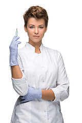 Image showing Portrait of lady surgeon showing syringe 