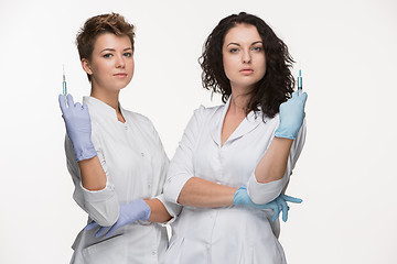 Image showing Portrait of two women surgeons showing syringes 