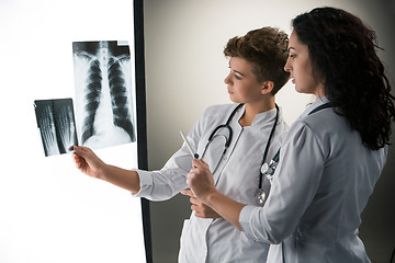 Image showing Two attractive young doctors looking at x-ray results