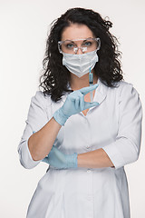 Image showing Portrait of lady surgeon showing syringe over white background