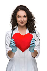 Image showing Pretty woman doctor holding a red heart