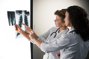 Image showing Two attractive young doctors looking at x-ray results