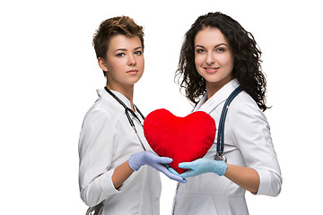 Image showing Two doctors holding a red heart