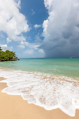 Image showing Beach on tropical island. Clear blue water, sand, clouds. 