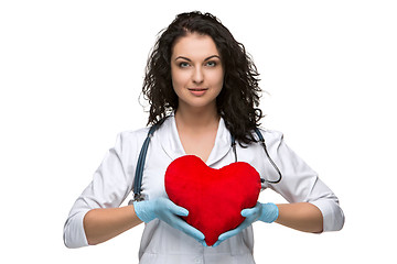Image showing Pretty woman doctor holding a red heart