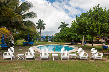 Image showing Swimming pool, palm trees and sky