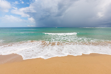 Image showing Beach on tropical island. Clear blue water, sand, clouds. 