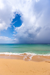 Image showing Beach on tropical island. Clear blue water, sand, clouds. 