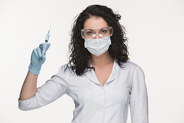 Image showing Portrait of lady surgeon showing syringe over white background