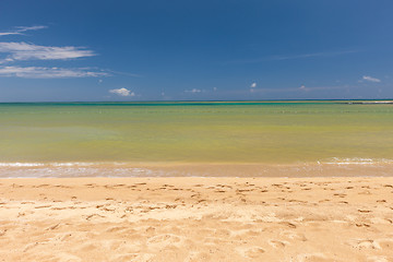 Image showing Beach on tropical island. Clear blue water, sand, clouds. 