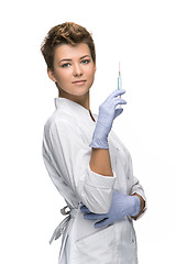 Image showing Portrait of lady surgeon showing syringe 
