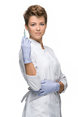 Image showing Portrait of lady surgeon showing syringe 