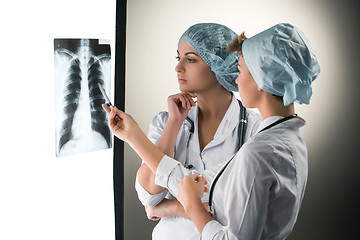 Image showing Two attractive young doctors looking at x-ray results