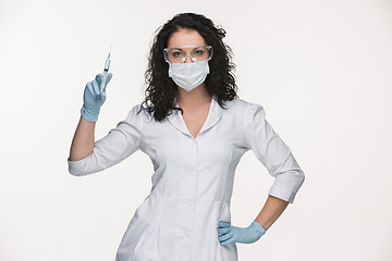 Image showing Portrait of lady surgeon showing syringe over white background