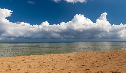 Image showing Beach on tropical island. Clear blue water, sand, clouds. 