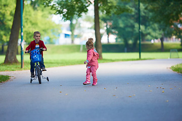 Image showing boy and girl with bicycle