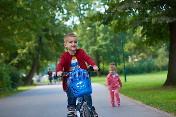 Image showing boy and girl with bicycle
