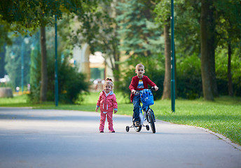 Image showing boy and girl with bicycle