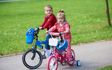 Image showing boy and girl with bicycle