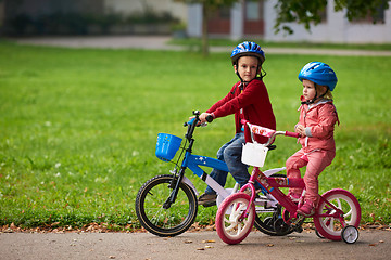 Image showing boy and girl with bicycle