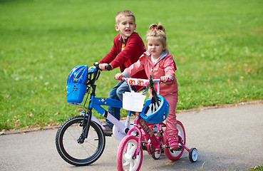 Image showing boy and girl with bicycle