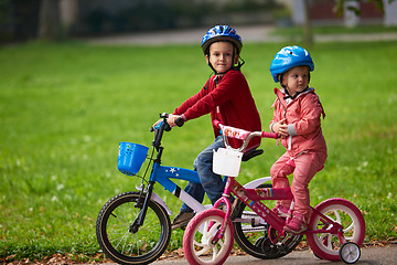 Image showing boy and girl with bicycle