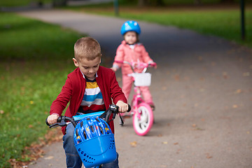 Image showing boy and girl with bicycle