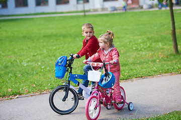 Image showing boy and girl with bicycle