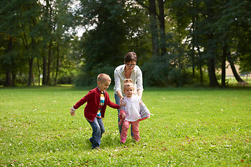 Image showing happy family playing together outdoor in park