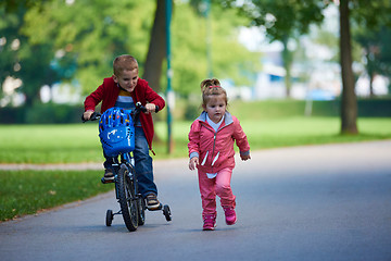 Image showing boy and girl with bicycle