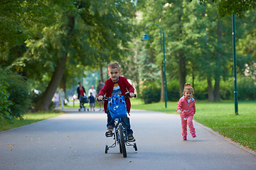 Image showing boy and girl with bicycle