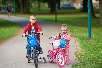 Image showing boy and girl with bicycle