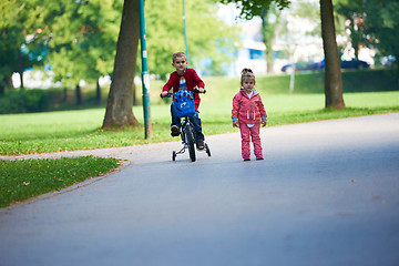 Image showing boy and girl with bicycle