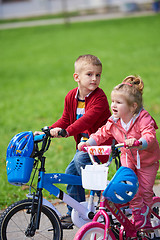 Image showing boy and girl with bicycle