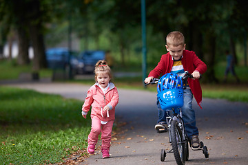 Image showing boy and girl with bicycle